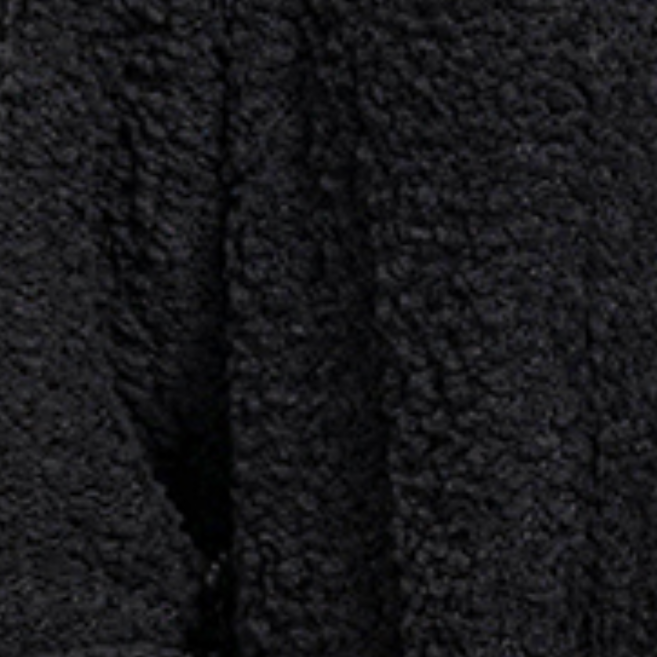Close-up of a textured black fabric with a pattern